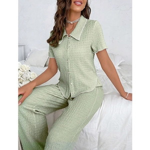 Women's light green pajama set with button-down short sleeve shirt and textured pants