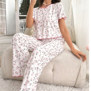 Women's floral pajama set with short-sleeve top and long wide-leg pants in white and pink