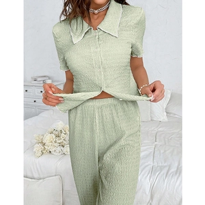 Close-up of light green seersucker pajama set with white lapel and textured fabric finish