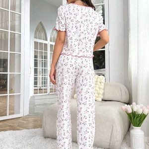 Women floral pajama set with short sleeve top and long pants featuring pink ruffled edges