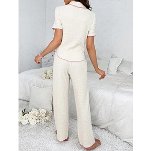 Detail of waffle texture fabric and pink piping on women's cream pajama set