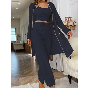 Detail view of dark blue ribbed knit lounge set with white piping and drawstring pants