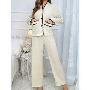 Women's V-neck pajama set in cream with black contrast wavy trim and waffle texture