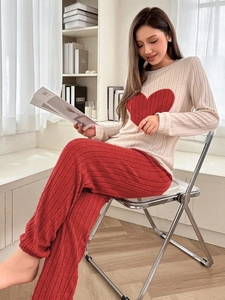 Close-up of soft knit pajamas featuring a red heart pattern and ribbed texture detail