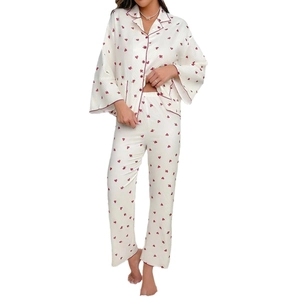 Women's pajama set featuring red heart print on cream fabric with long sleeves and pants