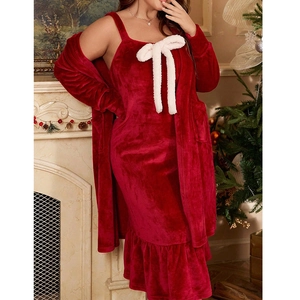 Detail of red plush lounge set with white bow and ruffle hem in a festive home setting