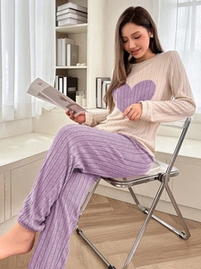Detail of soft ribbed pajama set with heart pattern and purple lounge trousers