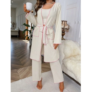 Detailed close-up of cream lounge set featuring pink piping and textured waffle fabric