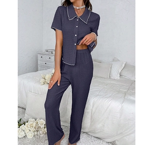 Detail of navy textured pajama set with white piping and short sleeve button-down top