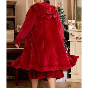 Women's red plush hooded bathrobe with cute ears in a cozy Christmas indoor setting