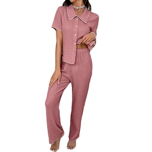 Women's pink textured pajamas set with button-down lapel shirt and matching long pants