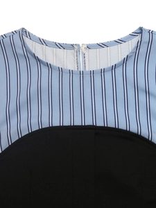 Close-up of crew neckline and back zipper on blue striped patchwork shirt