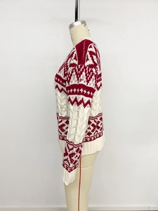 Detail of red and white Fair Isle knit sweater with ribbed cuffs on display stand