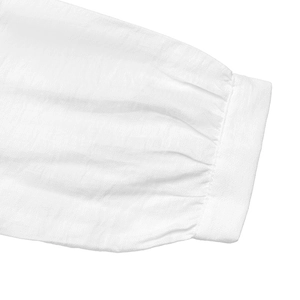 Detail of elegant ruffled cuffs and textured fabric on this white long-sleeve blouse