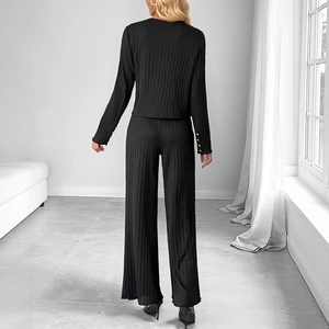 Elegant black knit two-piece set featuring texture top and wide-leg pants with gold buttons