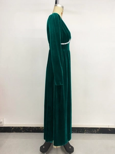 Macro shot of dark green velvet maxi dress showing heart lace trim and fabric texture