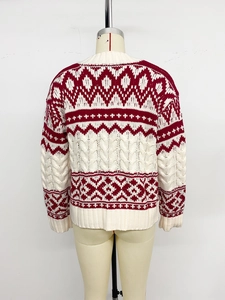 Detailed back view of Christmas sweater showing red jacquard and white cable knit patterns