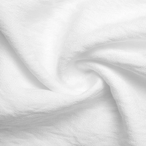 Detailed macro shot of white textured cotton fabric with elegant ruffle fold details