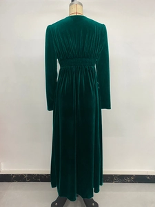 Detail of the elastic back waist craftsmanship on a dark green velvet long sleeve dress
