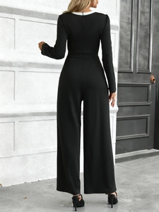 Close-up of the back view showing the sleek fit and hidden zipper of the black jumpsuit