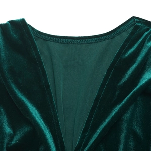 Detail of elegant V-neckline on dark green velvet dress with smooth texture