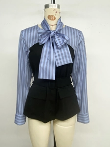 Detail of blue striped shirt with oversized bow neckline and black belted patchwork hem