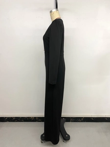 Side view of elegant black long-sleeve jumpsuit with wide-leg cut and high waist design