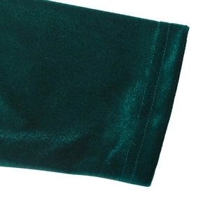 Detailed macro view of dark green velvet fabric with professional stitching and texture