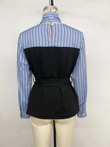 Rear view of striped blue and white shirt featuring black patch detail and waist belt