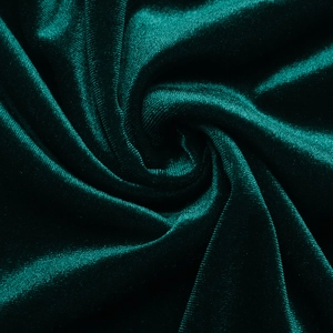 Close-up of deep green velvet fabric texture showing glossy finish and soft drape