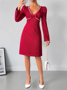 Détail de la robe rouge en tweed avec col en V, garniture de perles et un nœud élégant