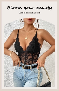 Close-up of black floral lace bodysuit with V-neck and delicate straps on female model
