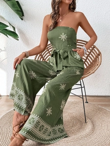 Detail of green floral strapless wide-leg jumpsuit with waist tie and side pockets