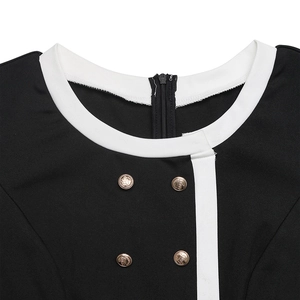 Detail of color-block romper featuring gold embossed buttons and a hidden back zipper
