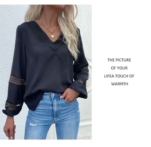 Detail of elegant black V-neck shirt with lace stitching and long sleeves for women