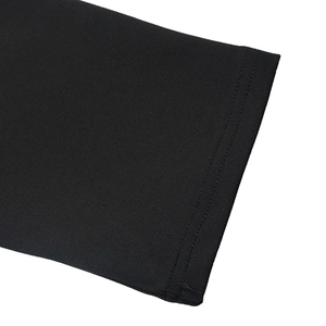 Close-up of double-needle stitching on the cuffs of a black long sleeve jumpsuit