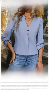 Detail of light blue women's V-neck blouse showing the collar buttons and adjustable sleeves