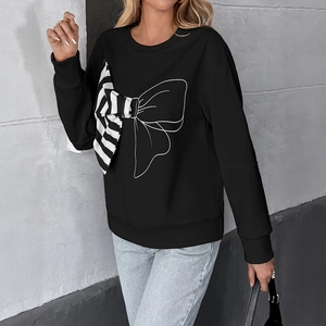 Black long sleeve sweatshirt featuring a large patchwork bow and dropped shoulders