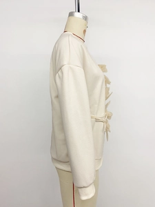 Side view of cream oversized sweatshirt with 3D floral folds and drawstring details