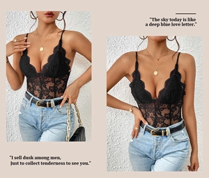 Detailed view of black lace bodysuit with deep V-neck and intricate floral embroidery