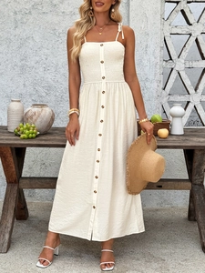 Detail of smocked bodice and button-down front on a cream summer maxi dress