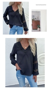 Detail view of V-neckline and intricate black lace stitching on long sleeve blouse