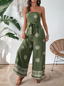Detail of olive green strapless jumpsuit with white floral embroidery and waist tie