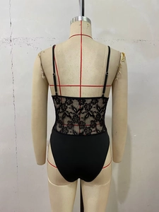 Detail view of the back of a black lace bodysuit with floral patterns on a mannequin