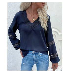 Detail of dark blue V-neck blouse with lace inserts and delicate hollowed-out embroidery