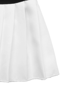 Detailed close-up showing white pleated velvet fabric with black contrast waist trim