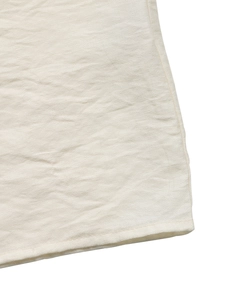 Detailed macro view of the textured off-white fabric with professional hemmed edges