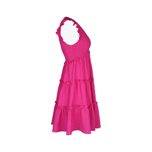 Détail de la robe rose vif montrant les bretelles à volants et le bustier froncé