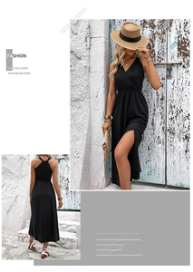 Detail of black summer maxi dress with deep V-neck, high slit and open cross-back design