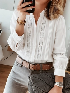Detail of white lace long sleeve blouse with ruffled stand collar and hollow out stitching
